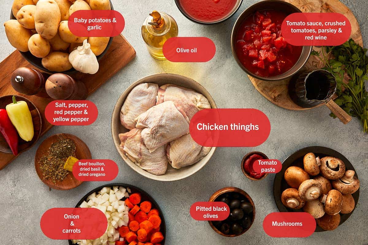 Flay lay photo of chicken thighs, red wine, tomato passata, crushed tomatoes, carrot, crushed beed bullion cube, pitted black olives, mushroom, red pepper flakes, salt and pepper, dried basil, dried oregano, fresh parsley, tomato paste, garlic, yellow and red bell pepper, onion, baby potatoes, olive oil