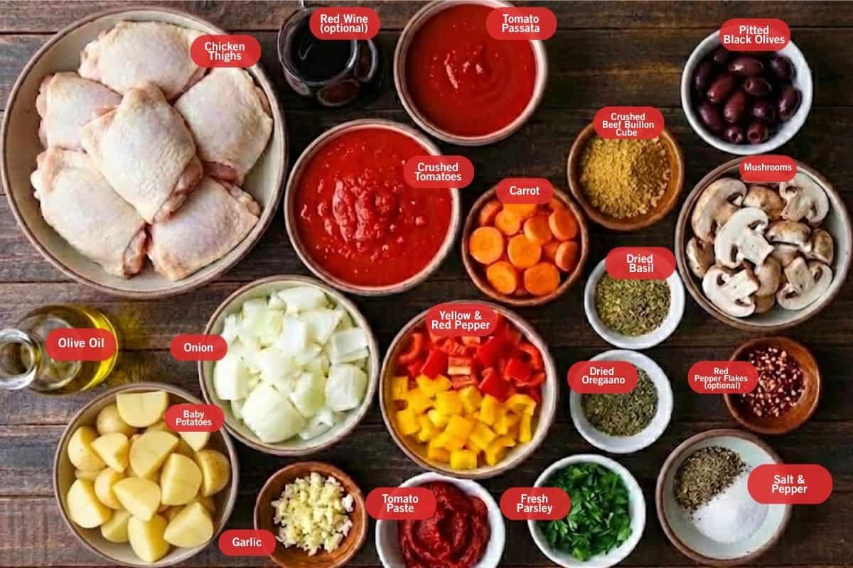 Flay lay photo of chicken thighs, red wine, tomato passata, crushed tomatoes, carrot, crushed beed bullion cube, pitted black olives, mushroom, red pepper flakes, salt and pepper, dried basil, dried oregano, fresh parsley, tomato paste, garlic, yellow and red bell pepper, onion, baby potatoes, olive oil