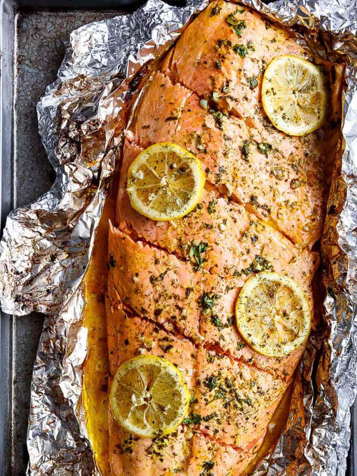 Lemon Butter Garlic Salmon with lemon slices on a foil