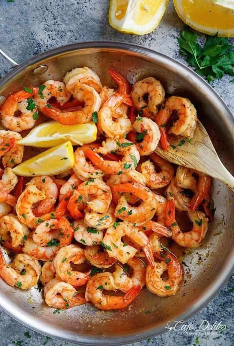 Lemon Garlic Butter Shrimp is the most easiest and flavour packed shrimp! With the best flavour combination and ready in under 15 minutes, this easy to throw together meal can be served over anything! | https://cafedelites.com