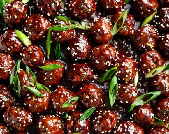 Tender Mongolian Glazed Meatballs are not only FILLED with Asian flavour -- they are smothered in the BEST homemade Mongolian sauce to wow your guests! | https://cafedelites.com