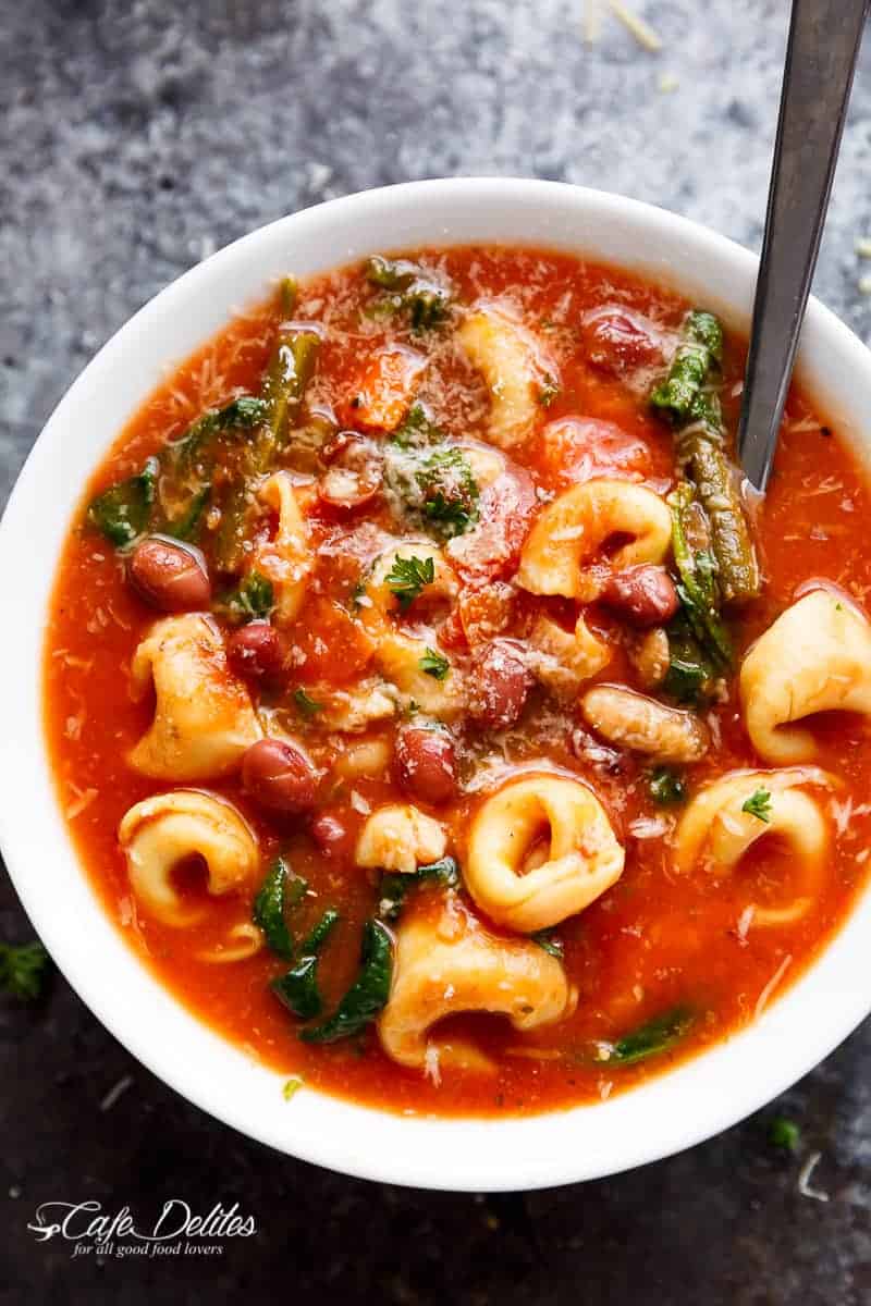 Slow Cooker Tortellini Minestrone Soup is a twist on the traditional minestrone, using tortellini instead of plain pasta! Delicious comfort food in a bowl! | https://cafedelites.com