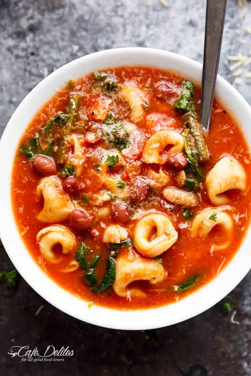 Slow Cooker Tortellini Minestrone Soup is a twist on the traditional minestrone, using tortellini instead of plain pasta! Delicious comfort food in a bowl! | https://cafedelites.com