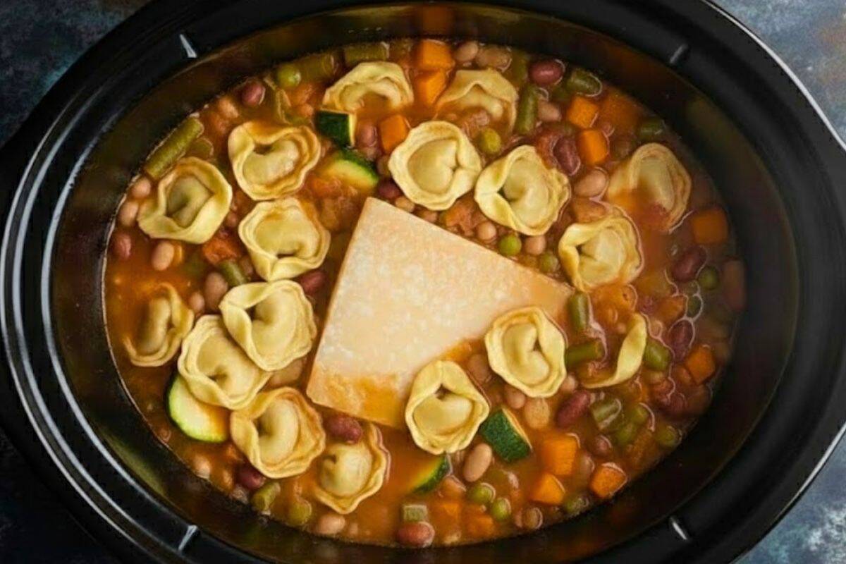 Stir in the parmesan rind, zucchini, white beans, red beans, and tortellini.