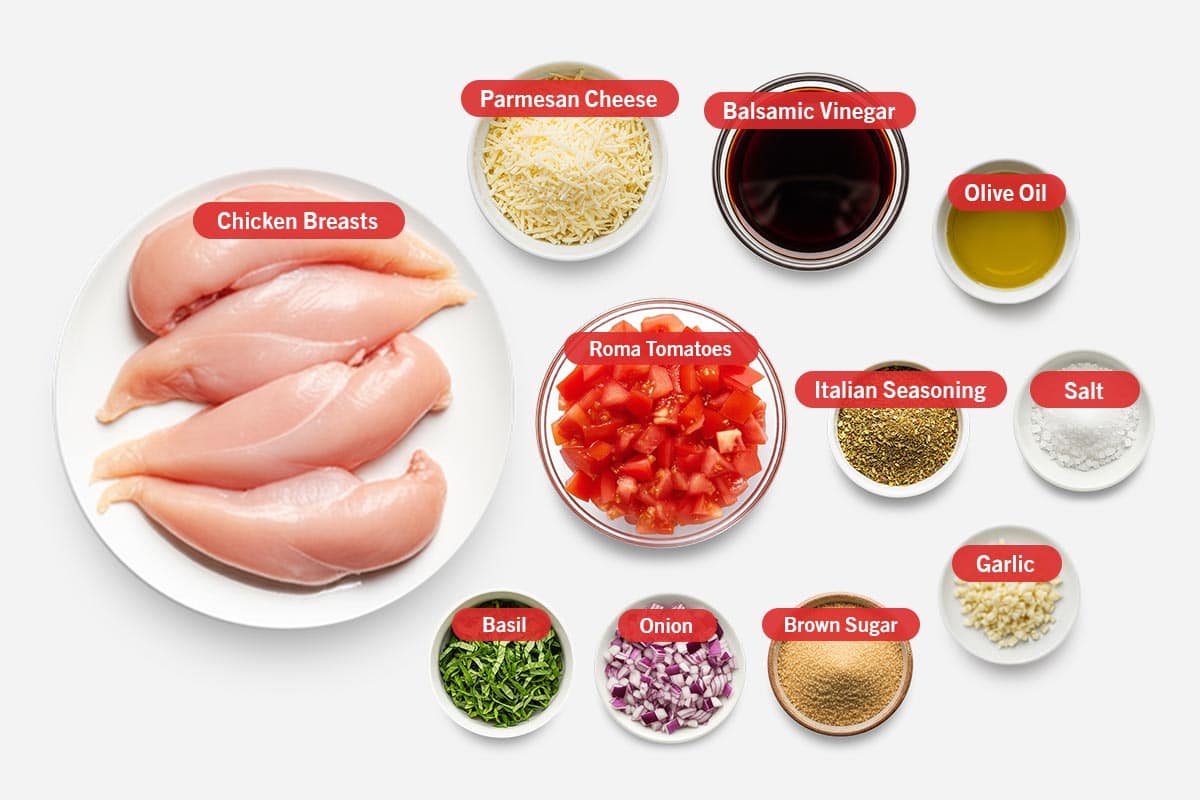 Top shot of ingredients: Chicken breasts, parmesan cheese, balsamic vinegar, olive oil, roma tomatoes, Italian seasoning, salt, basil, onion, brown sugar, and garlic.