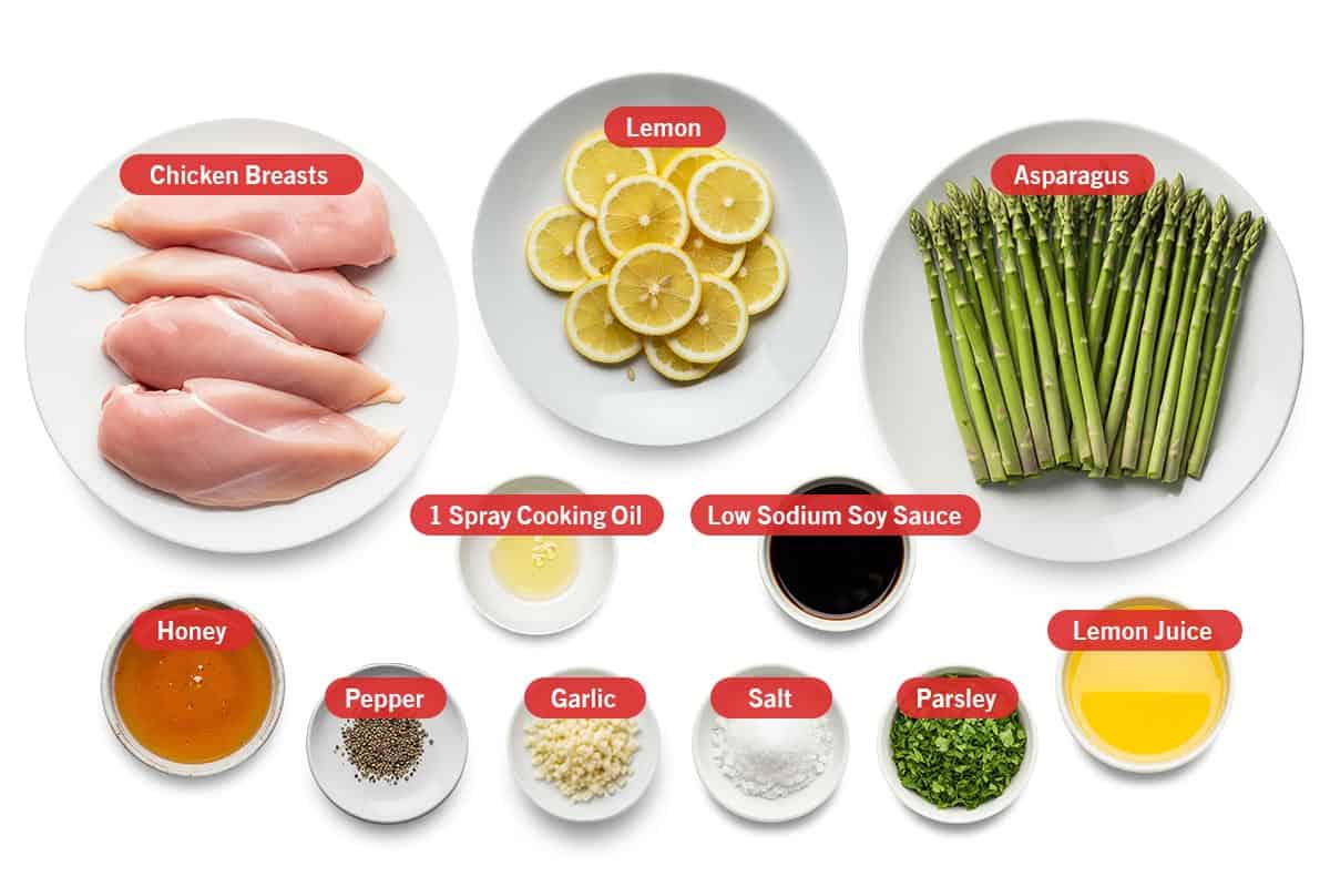 Top shot of ingredients: Chicken breasts, lemon, asparagus, 1 spray cooking oil, low sodium soy sauce, honey, pepper, garlic, salt, parsley, and lemon juice.