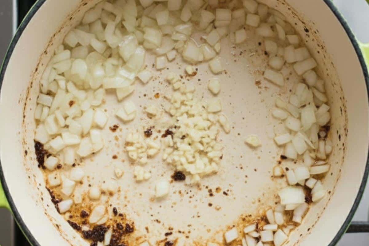 Sautéing onion and garlic in the pan.