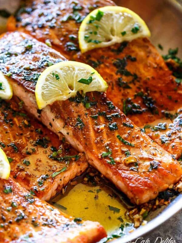 Pan Seared Salmon with Lemon Garlic Butter Sauce with lemon wedges