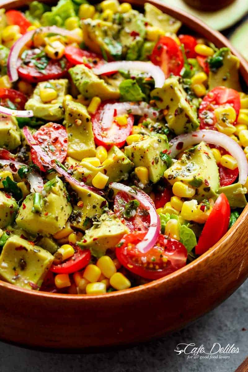 Avocado Corn Tomato Salad with a lime juice dressing is delicious served on its own, or as a side that easily pairs with anything on your plate! | https://cafedelites.com