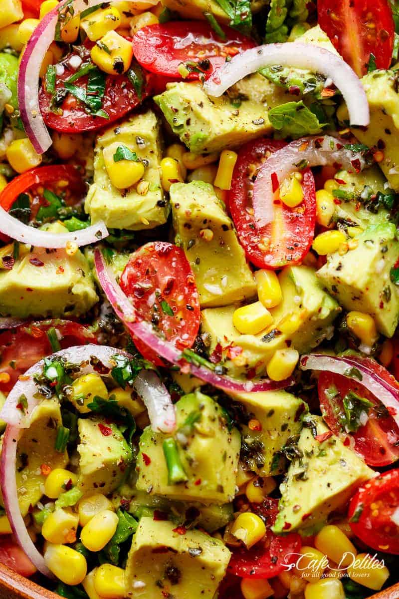 Avocado Corn Tomato Salad with a lime juice dressing is delicious served on its own, or as a side that easily pairs with anything on your plate! | https://cafedelites.com