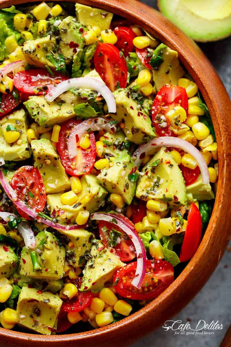 Avocado Corn Tomato Salad with a lime juice dressing is delicious served on its own, or as a side that easily pairs with anything on your plate! | https://cafedelites.com