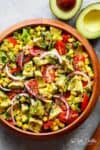 Avocado Corn Tomato Salad with a lime juice dressing is delicious served on its own, or as a side that easily pairs with anything on your plate! | https://cafedelites.com