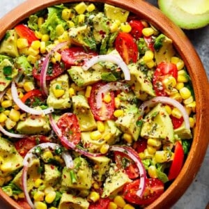 Avocado Corn Tomato Salad with a lime juice dressing in a bowl