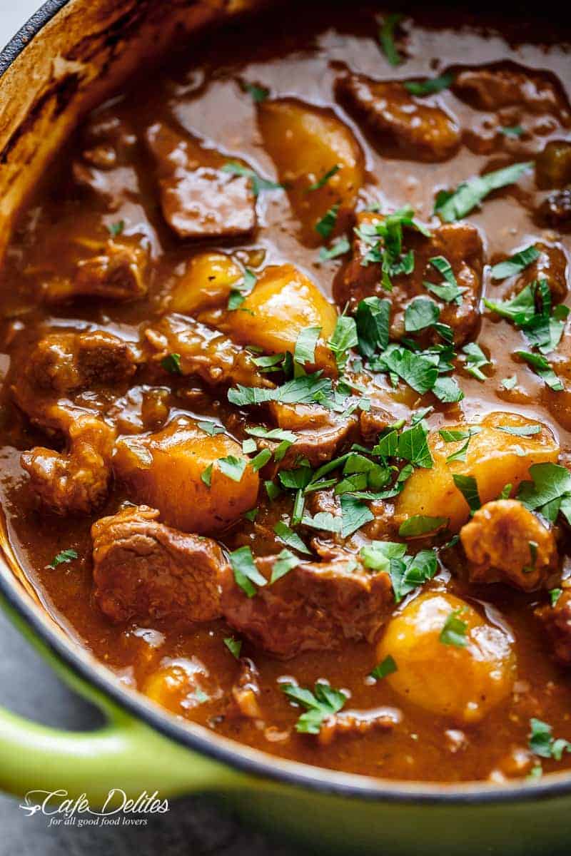 Beef And Guinness Stew is a heart warming bowl of comfort! Oven slow cooked beef, simmered in a rich Guinness gravy, with so much flavour! | https://cafedelites.com