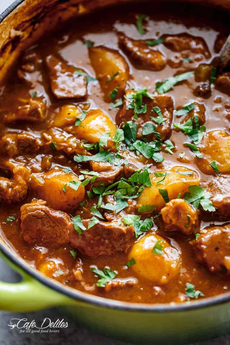 Beef And Guinness Stew is a heart warming bowl of comfort! Oven slow cooked beef, simmered in a rich Guinness gravy, with so much flavour! | https://cafedelites.com