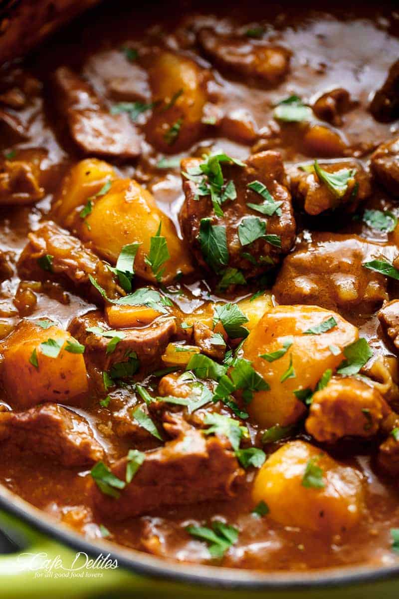 Beef And Guinness Stew is a heart warming bowl of comfort! Oven slow cooked beef, simmered in a rich Guinness gravy, with so much flavour! | https://cafedelites.com
