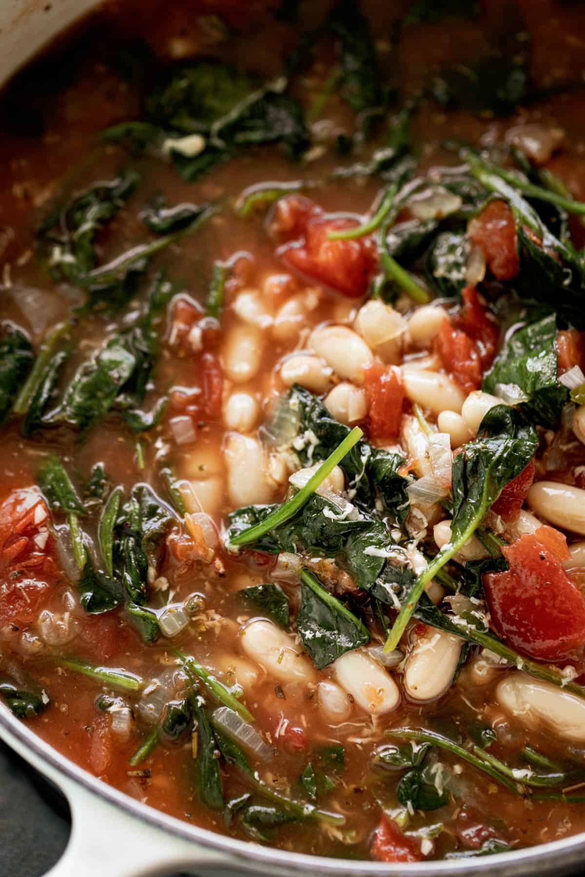 White Bean Parmesan Spinach Soup ready in 10 minutes is may kind of soup! Make a double batch and have plenty of leftovers for the weekly dinner rush! | https://cafedelites.com