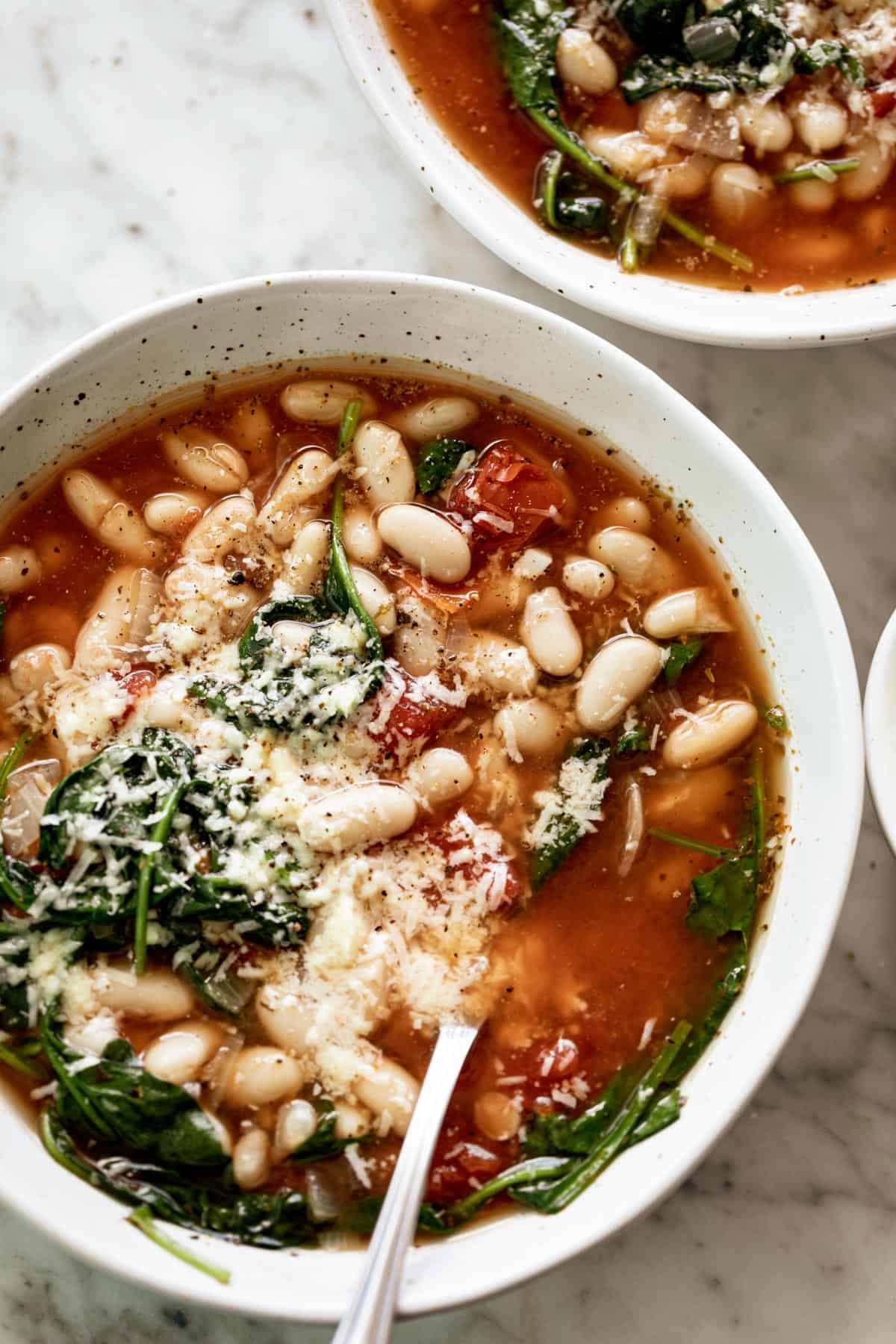 White Bean Parmesan Spinach Soup ready in 10 minutes is may kind of soup! Make a double batch and have plenty of leftovers for the weekly dinner rush! | https://cafedelites.com