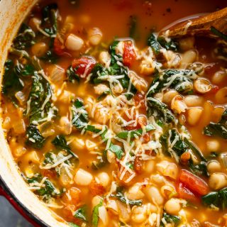 White Bean Parmesan Spinach Soup ready in 10 minutes is may kind of soup! Make a double batch and have plenty of leftovers for the weekly dinner rush! | https://cafedelites.com
