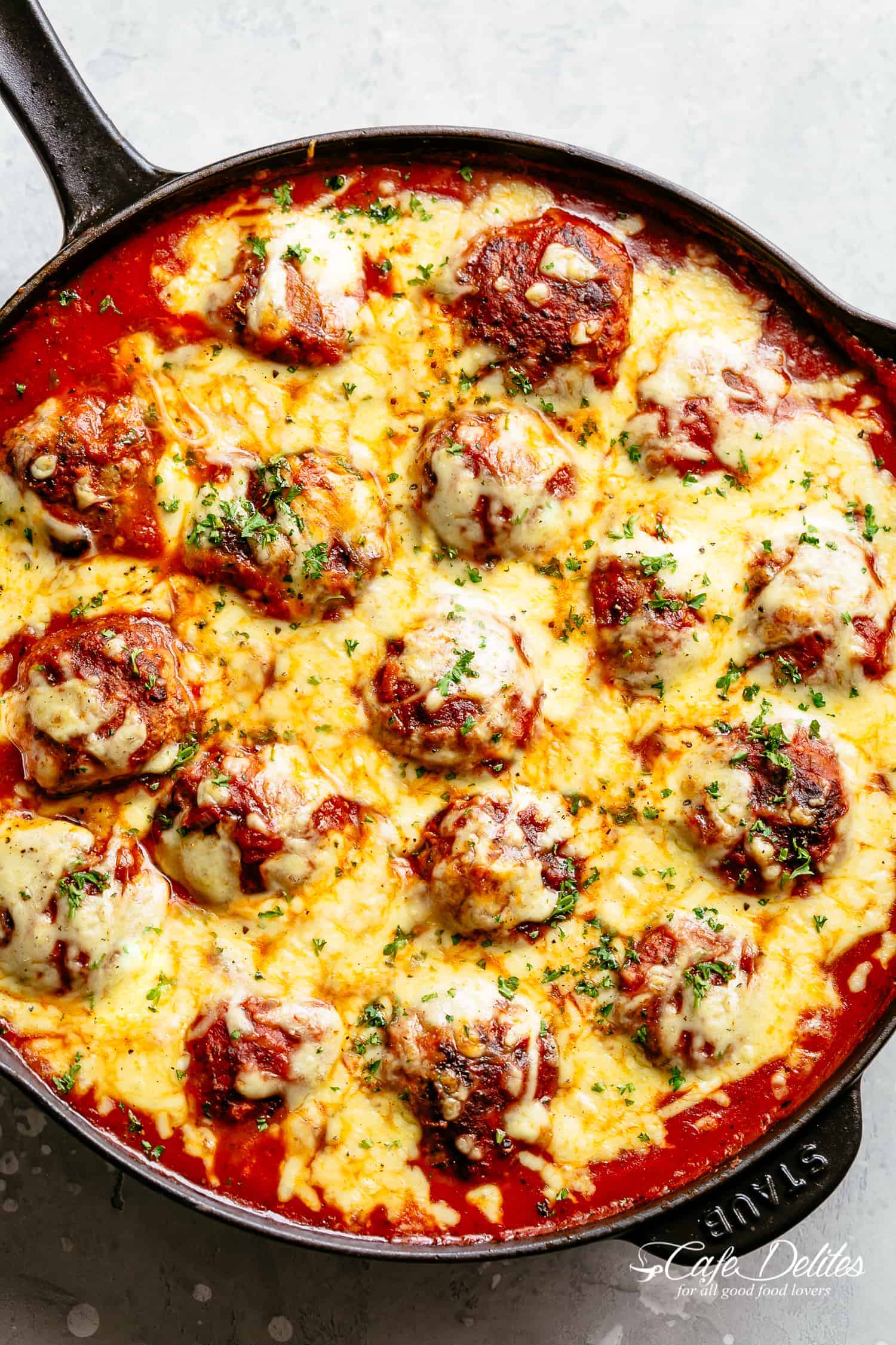 Cheesy Meatballs are soft, juicy and tender, simmered in a rustic homemade tomato sauce. Topped with melted mozzarella cheese and serve over spaghetti for a delicious dinner!