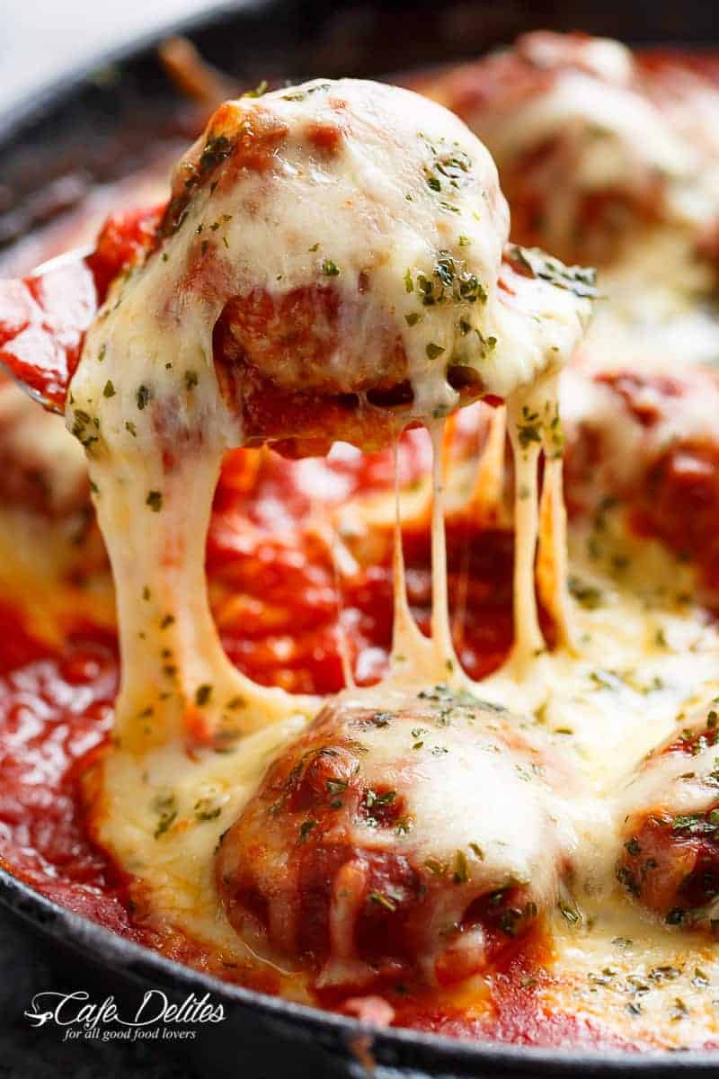 Mozzarella Meatballs In Tomato Sauce are juicy and soft meatballs, simmered in a homemade tomato sauce and topped with melted mozzarella! | https://cafedelites.com