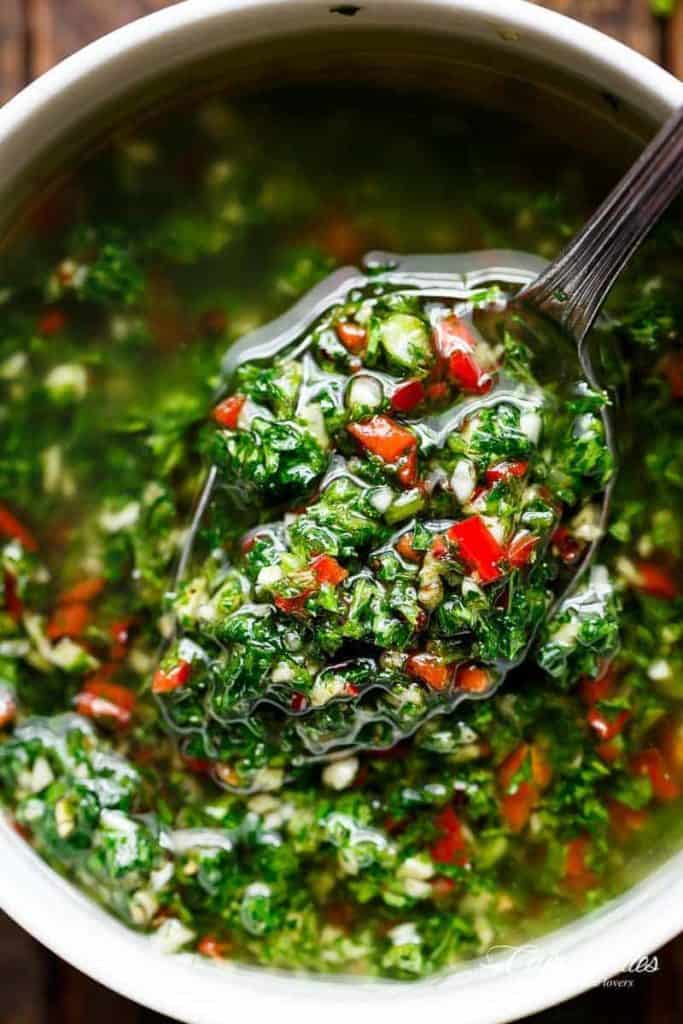 Authentic Chimichurri from Uruguay & Argentina is the best accompaniment to any barbecued or grilled meats! Also used to serve as a dressing on salads! | https://cafedelites.com