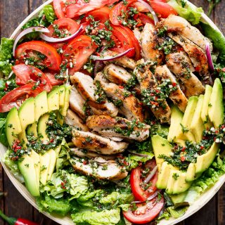 Grilled Chimichurri Chicken Avocado Salad is another meal in a salad! Using authentic chimichurri as a dressing that doubles as a marinade! | https://cafedelites.com
