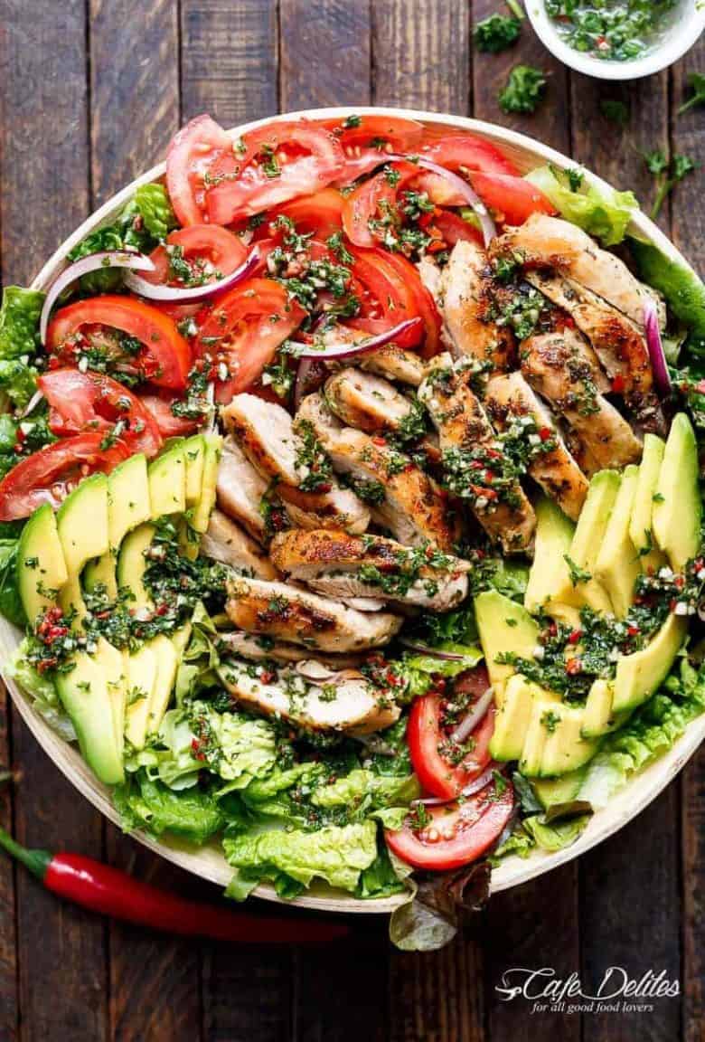 Grilled Chimichurri Chicken Avocado Salad is another meal in a salad! Using authentic chimichurri as a dressing that doubles as a marinade! | https://cafedelites.com