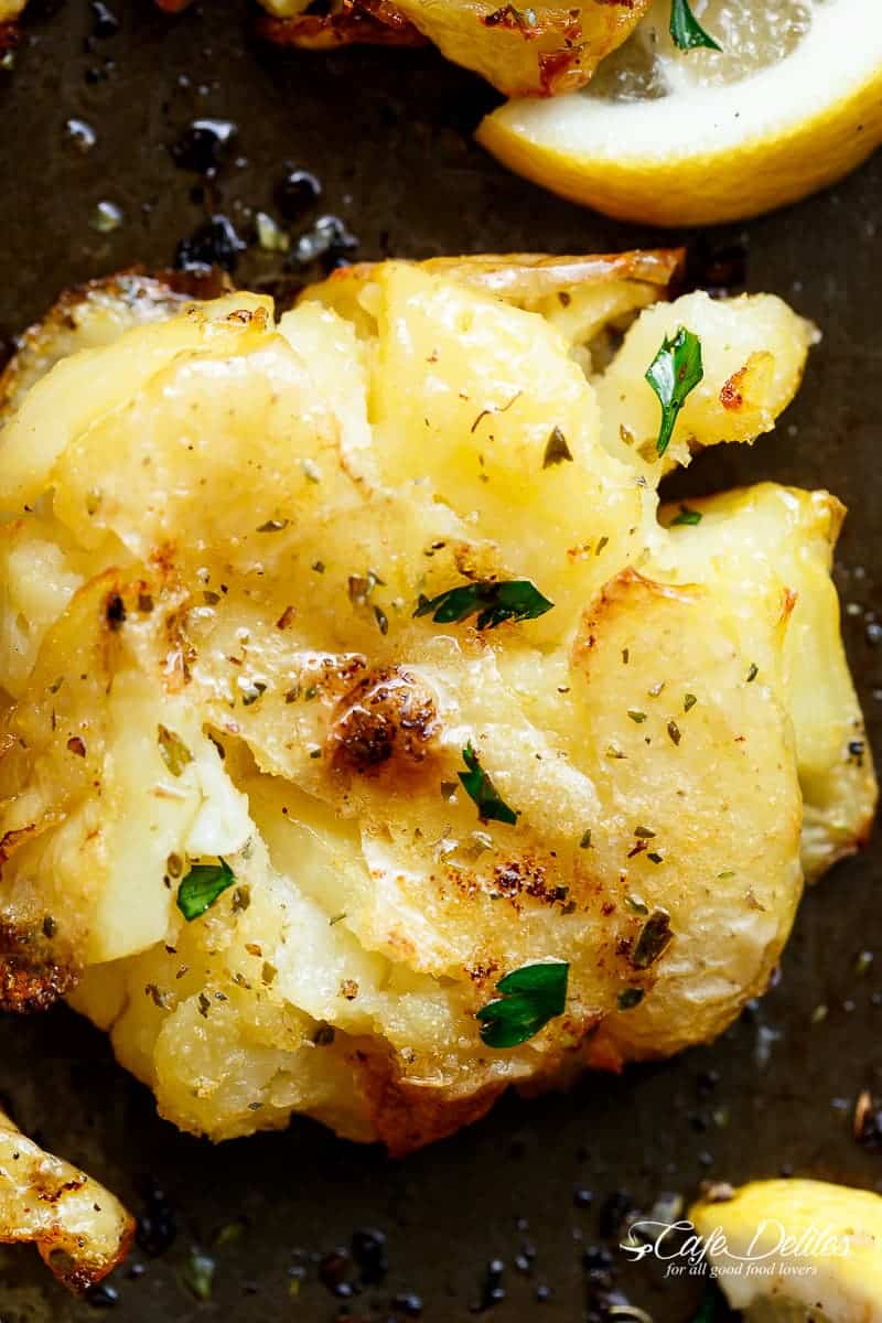 One of the best sides to accompany any meal are these Crispy Greek Lemon Smashed Potatoes! Crispy and golden on the outside, soft and fluffy on the inside! | https://cafedelites.com