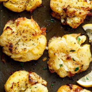 Crispy Greek Lemon Smashed Potatoes are Crispy and golden on the outside, soft and fluffy on the inside kept on a pan