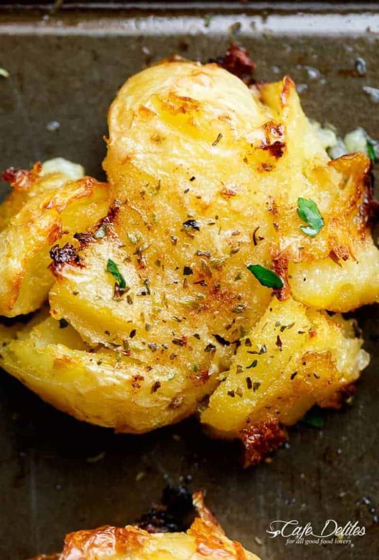 One of the best sides to accompany any meal are these Crispy Greek Lemon Smashed Potatoes! Crispy and golden on the outside, soft and fluffy on the inside! | https://cafedelites.com