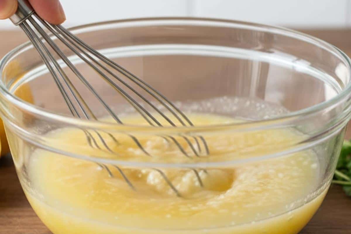 Stirred together butter, lemon juice, and garlic in a bowl.