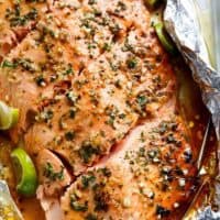 Honey Lime Garlic Butter Salmon in foil Is ready in under 30 MINUTES! Caramelized on the outside and falling apart tender on the inside! | https://cafedelites.com