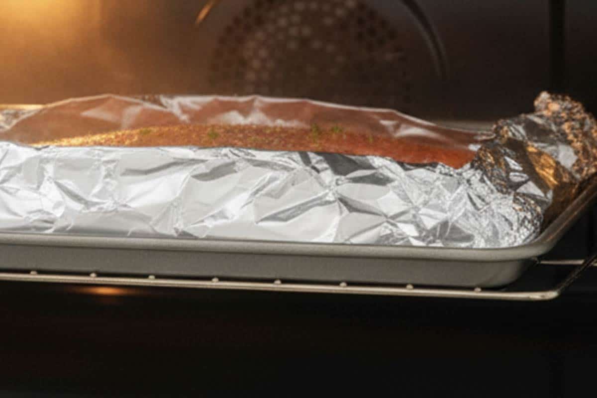 Placed the tray with salmon in the oven.