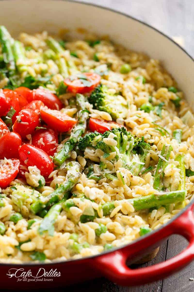 One Pot Orzo Primavera is full of green vegetables and a beautiful sauce with a hint of cream, garlic and lemon! All cooked in the one pan! | https://cafedelites.com