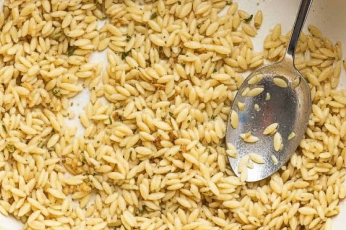 Stir in garlic and orzo pasta and cook for 2 minutes until it starts to brown.