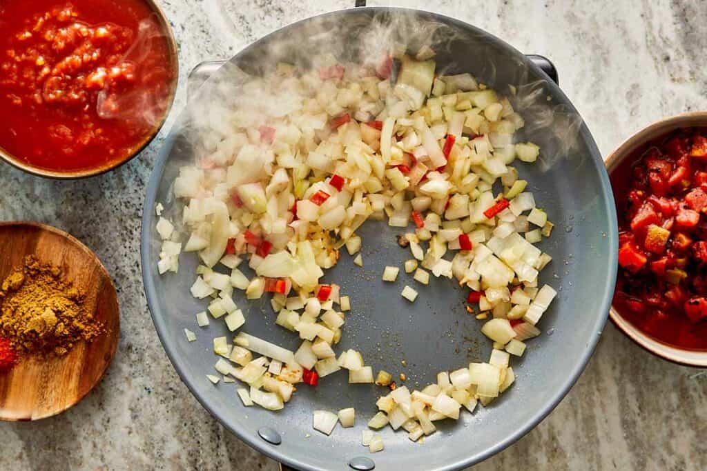 a top down view of a pan with diced up vegetables being fried in the pan - 6