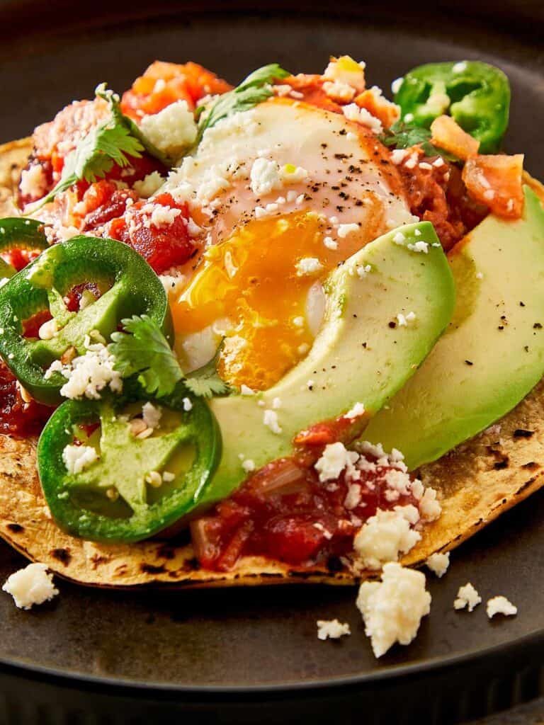 a close up top down view of a fully cooked huevos rancheros - 12