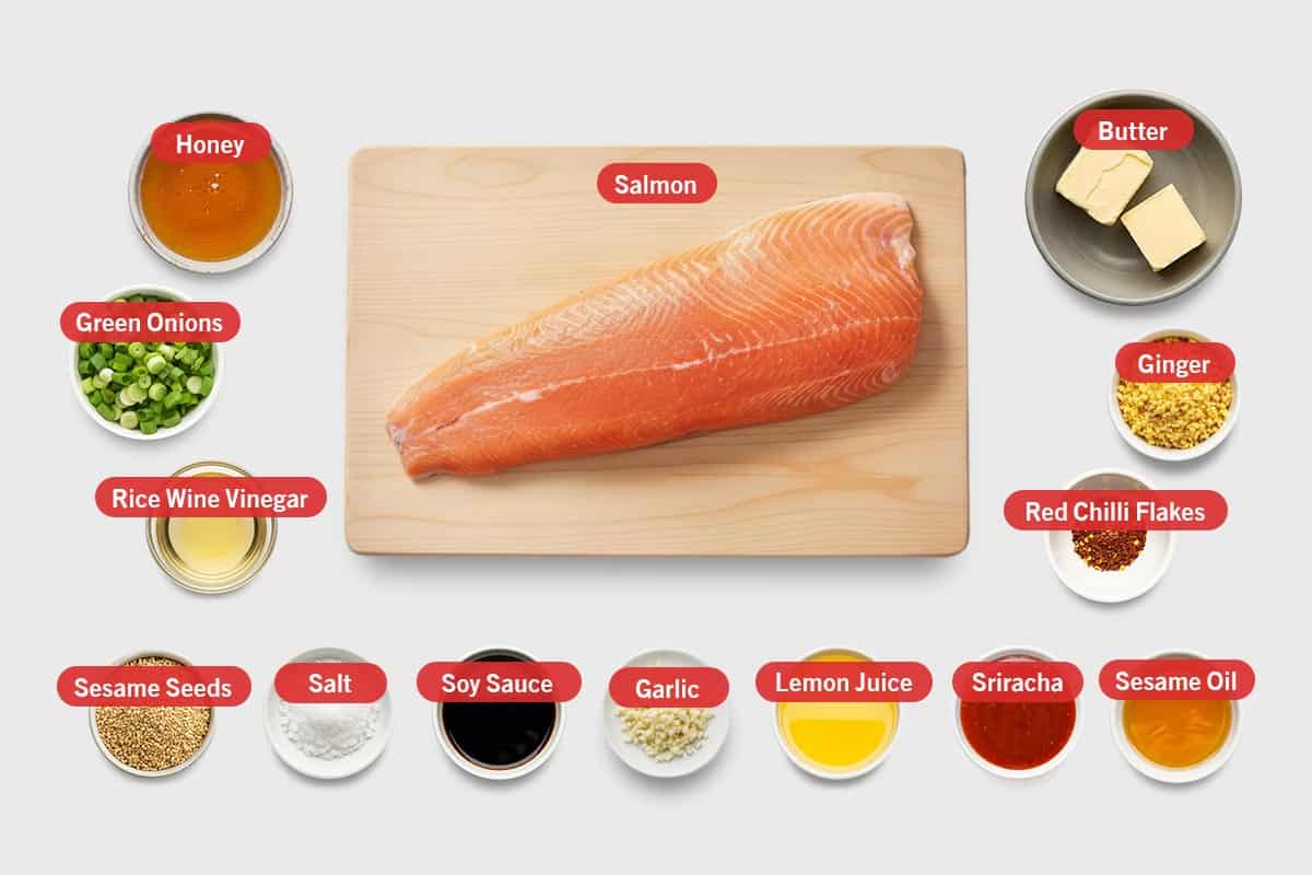 Top shot of ingredients: Honey, salmon, butter, green onions,  rice wine vinegar, sesame seeds, salt, soy sauce, garlic, lemon juice, Sriracha, sesame oil, red chilli flakes, and ginger.