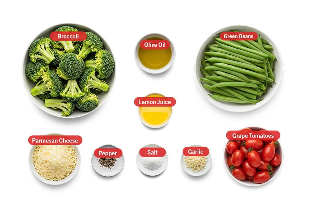 Top shot of ingredients: Broccoli, olive oil, lemon juice, green beans, parmesan cheese, pepper, salt, garlic, and grape tomatoes.