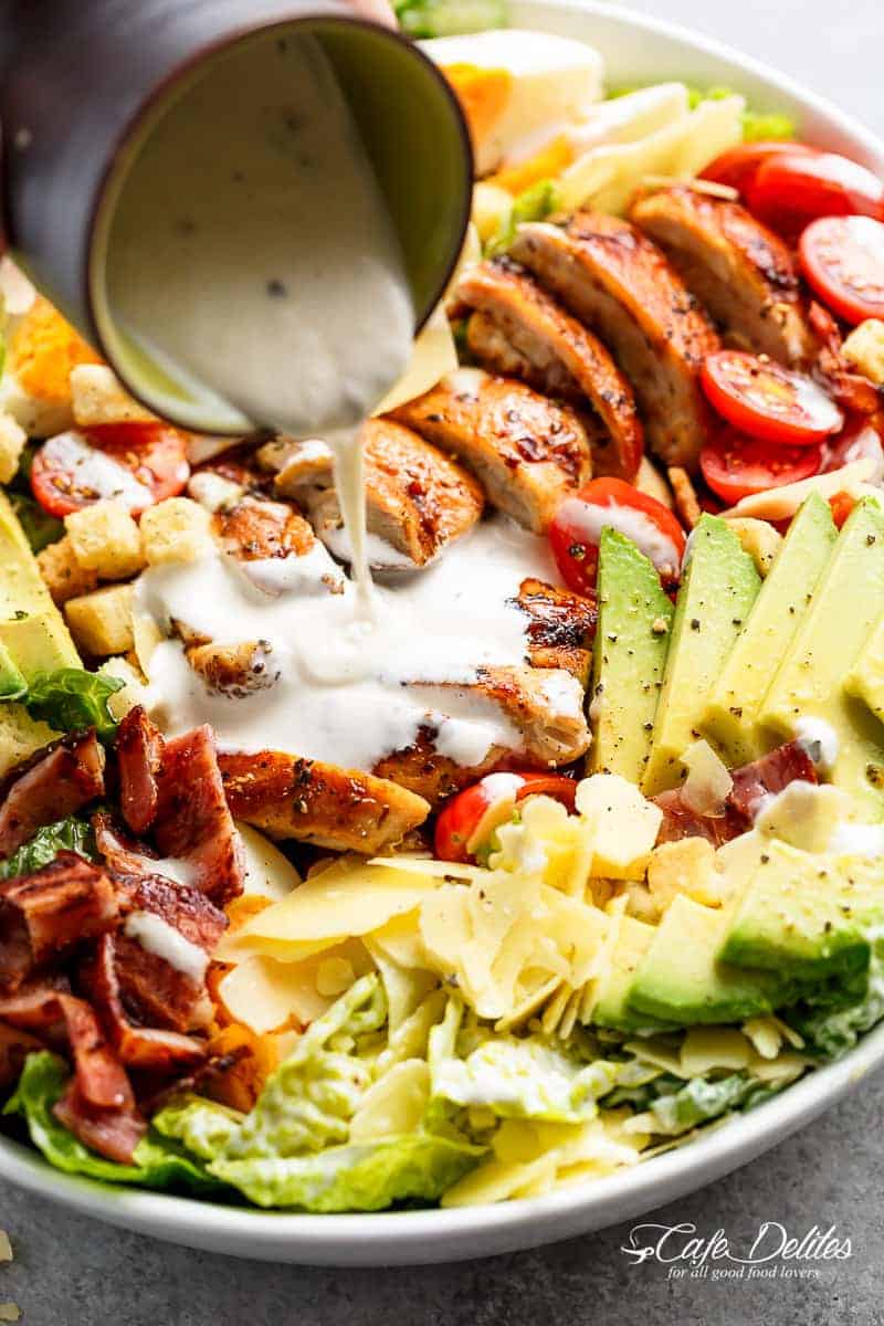 Grilled Chicken Cobb Caesar Salad is a meal in a salad Grilled Chicken Cobb Caesar Salad