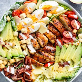 Grilled Chicken Cobb Caesar Salad is a meal in a salad, merging two of your favourites into one delicious bowl! Perfect for lunch or dinner! | https://cafedelites.com
