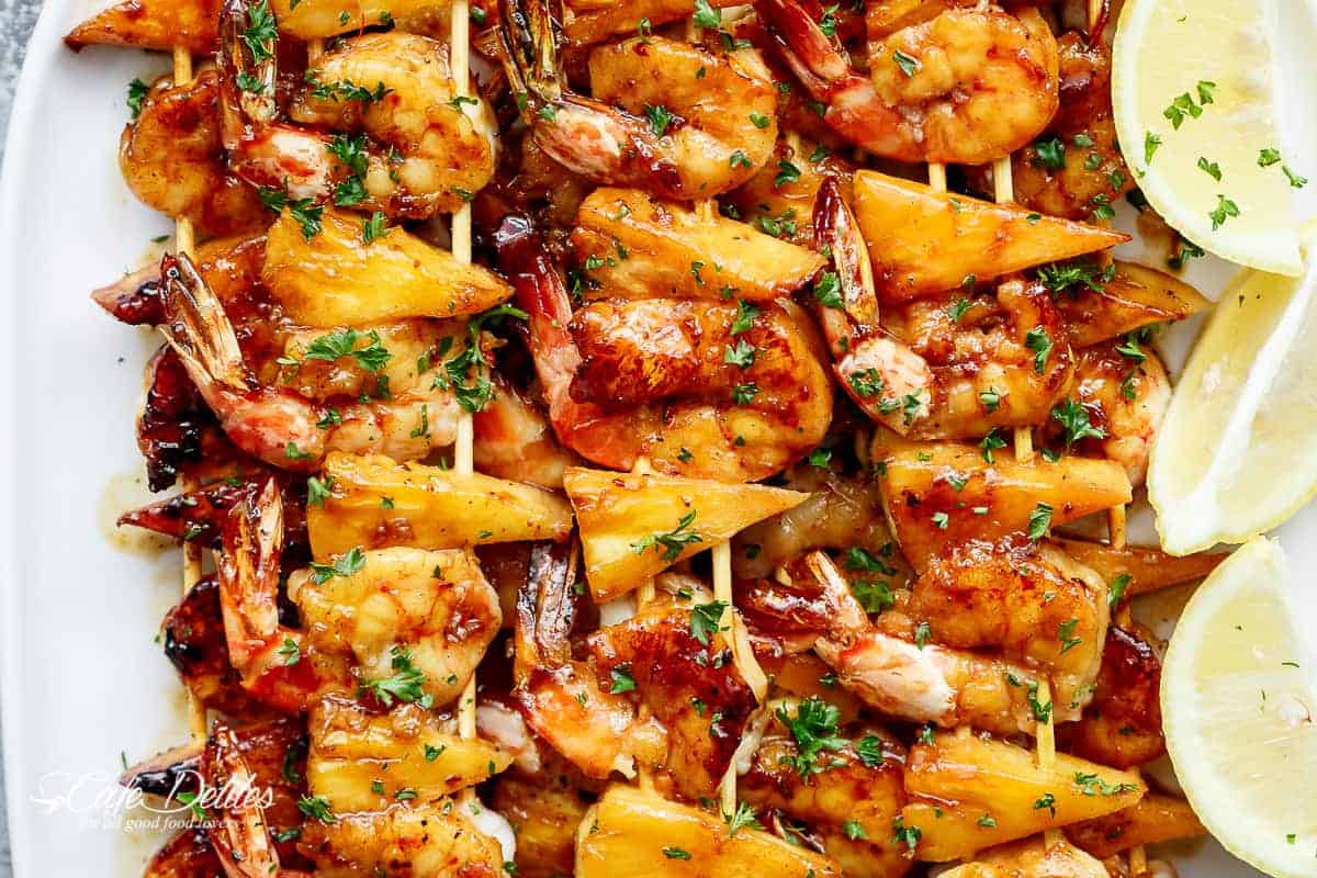 Honey Garlic Butter Shrimp Pineapple Skewers are cooked in the most incredible honey garlic butter sauce! Sweet and buttery, a family favourite! | https://cafedelites.com