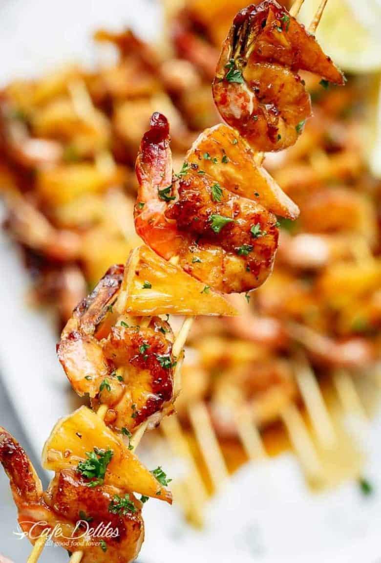 Honey Garlic Butter Shrimp Pineapple Skewers are cooked in the most incredible honey garlic butter sauce! Sweet and buttery, a family favourite! | https://cafedelites.com