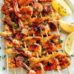 Honey Garlic Butter Shrimp Pineapple Skewers are cooked in the most incredible honey garlic butter sauce on a plater