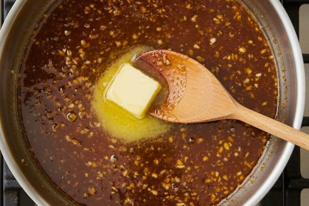 In a saucepan over low-medium, melt 2 tablespoons of butter with honey, garlic, and soy sauce.