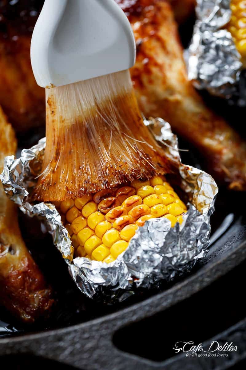 Bring your favourite Nando's chicken to the table with this Portuguese BBQ Peri Peri Chicken Recipe! PLUS the addition of juicy corn cobs in foil packets are charred for added flavour. | https://cafedelites.com