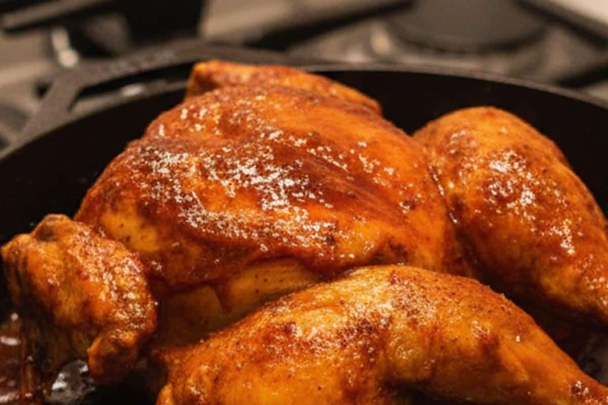 Searing the whole chicken in a pan.