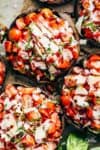 Grilled Bruschetta Portobello Mushrooms smothered in garlic butter are your new favourite way to eat a mushroom! Breakfast, Lunch OR dinner! | https://cafedelites.com