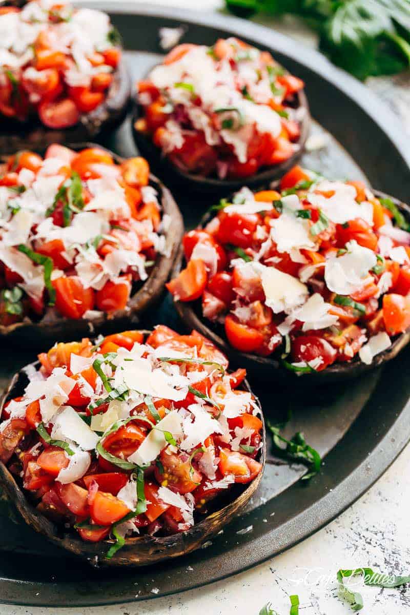 Grilled Bruschetta Portobello Mushrooms smothered in garlic butter are your new favourite way to eat a mushroom! Breakfast, Lunch OR dinner! | https://cafedelites.com